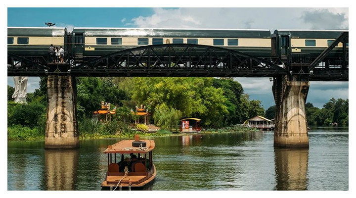 Toast to a golden sunset while crossing the legendary River Kwai